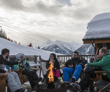 People Relaxing next to the warm fire at Panorama Mountain Resort