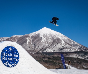 Snowboarder hitting large jump